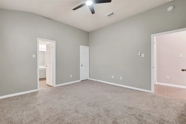 an empty room with a empty space and a ceiling fan