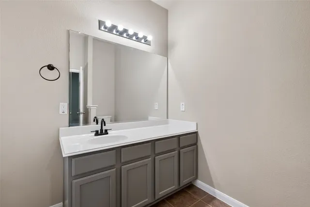a bathroom with a double vanity sink and a mirror