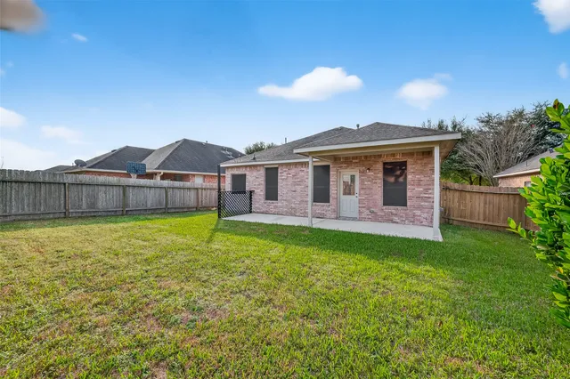 a view of a house with a backyard