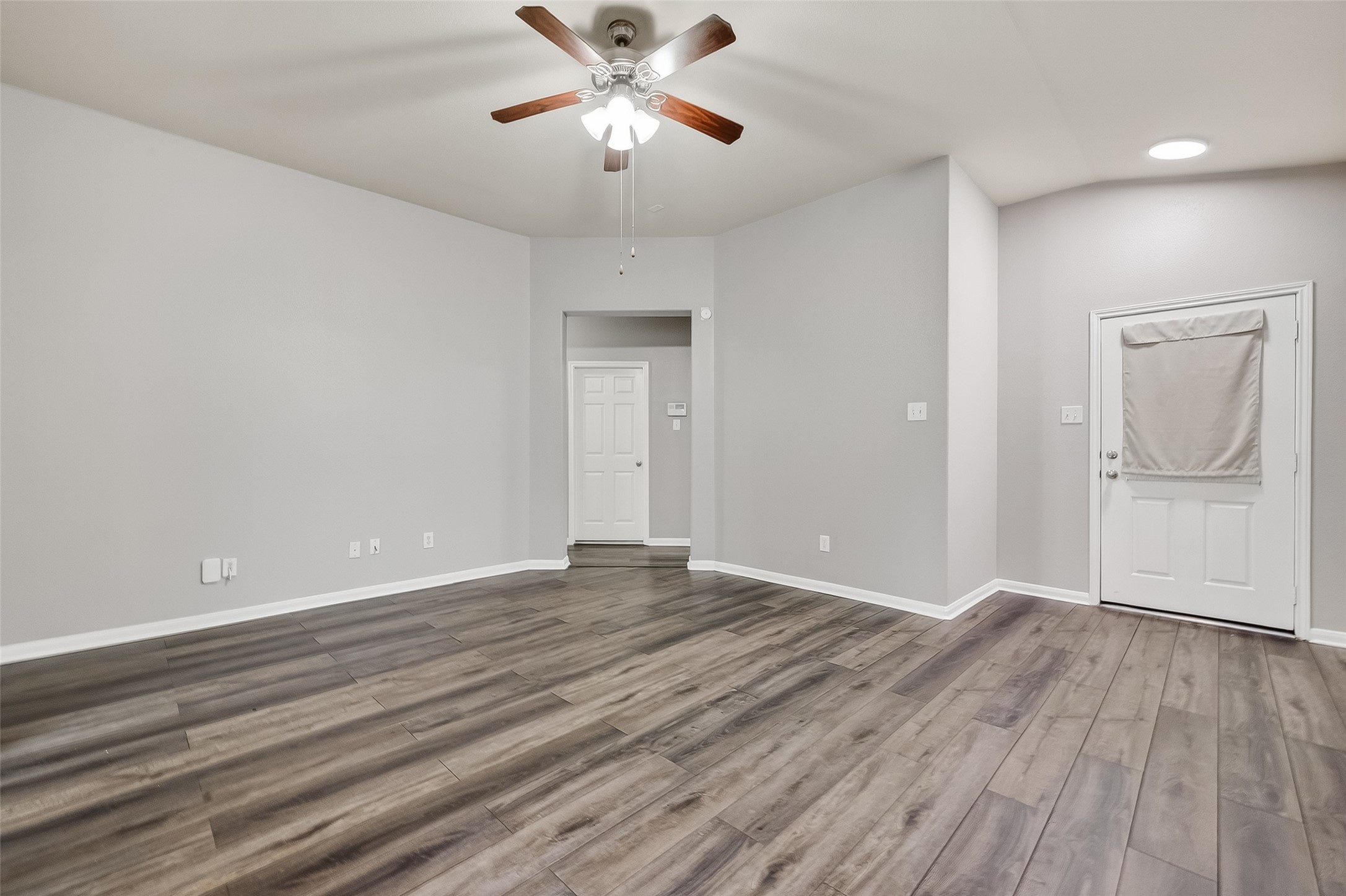 22419 Toronado Ridge Lane Porter, TX 77365 - Photo 4 of 35 a view of an empty room with wooden floor and a ceiling fan