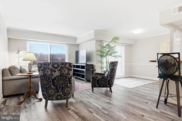 a living room with furniture and a lamp