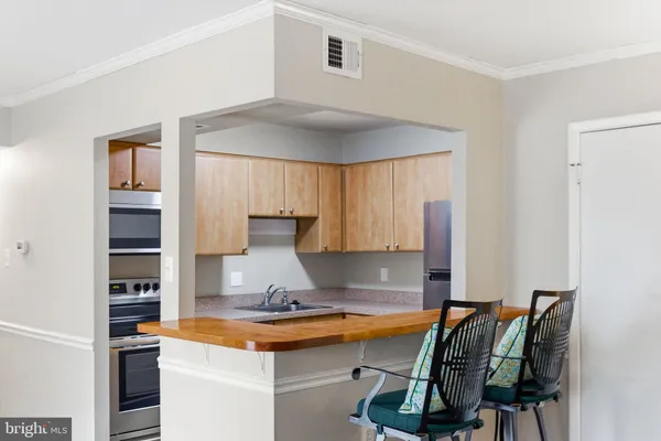 a kitchen with a refrigerator and a sink