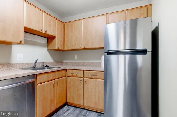 a kitchen with stainless steel appliances granite countertop a sink and a microwave