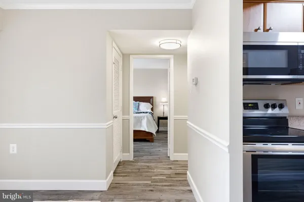 a view of a room with wooden floor and chairs