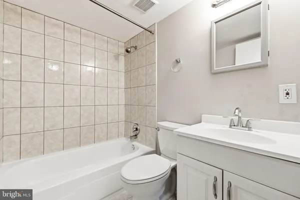 a white toilet sitting next to a bathroom sink
