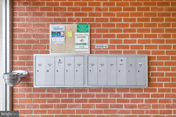 a bathroom with a wooden floor and a blue shower