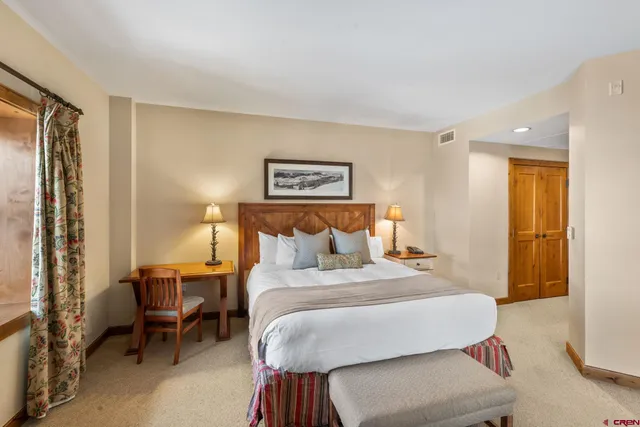 a bedroom with a bed and a table in it