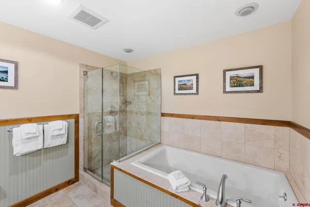 a bathroom with a tub and shower