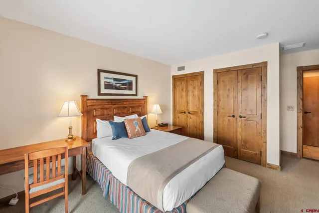 a bedroom with a bed and a baby crib