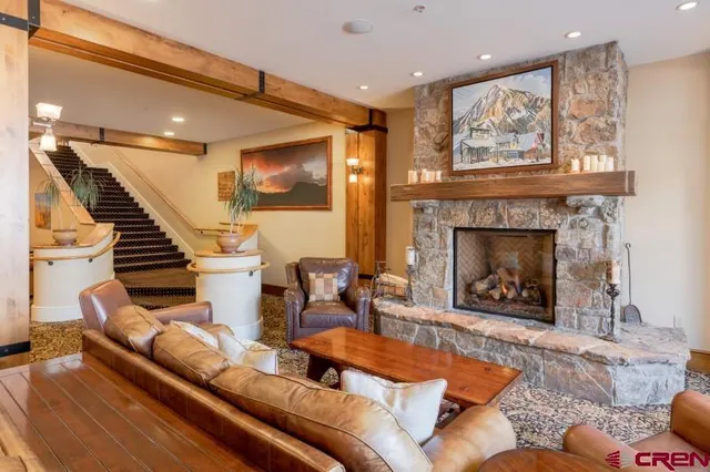 a living room with furniture and a fireplace