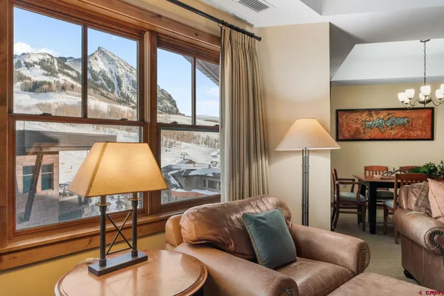 a living room with furniture and a lamp