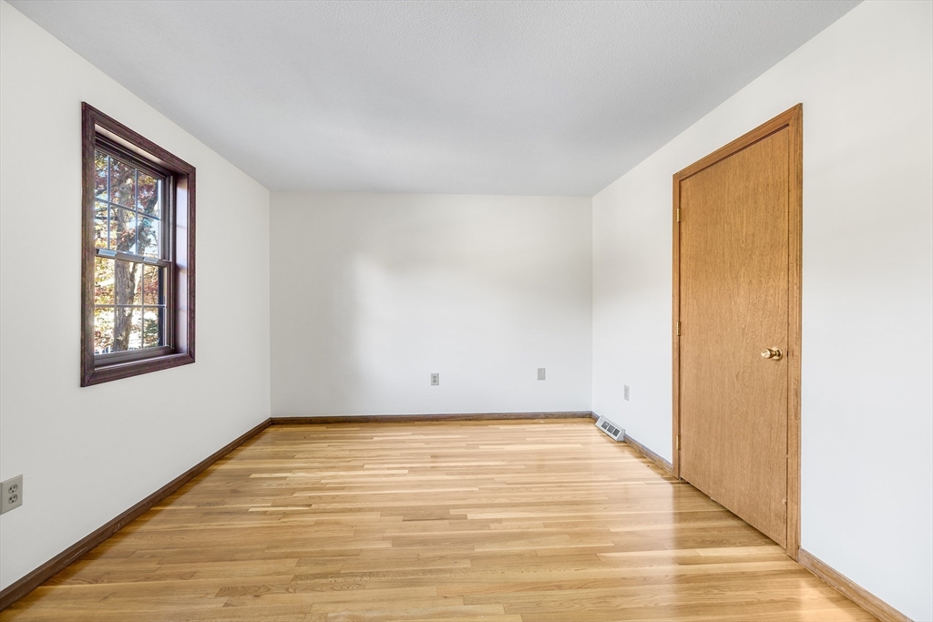 230 Irondequoit Road Franklin, MA 02038 - Photo 14 of 36 a view of empty room with wooden floor and fan