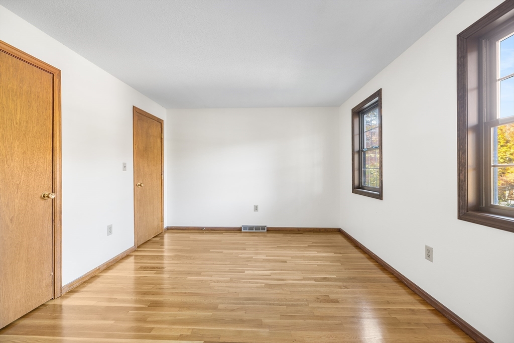 230 Irondequoit Road Franklin, MA 02038 - Photo 15 of 36 a view of an empty room with wooden floor and a window