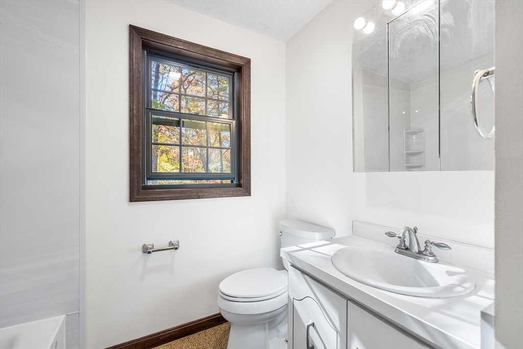 230 Irondequoit Road Franklin, MA 02038 - Photo 20 of 36 a bathroom with a toilet sink vanity and mirror
