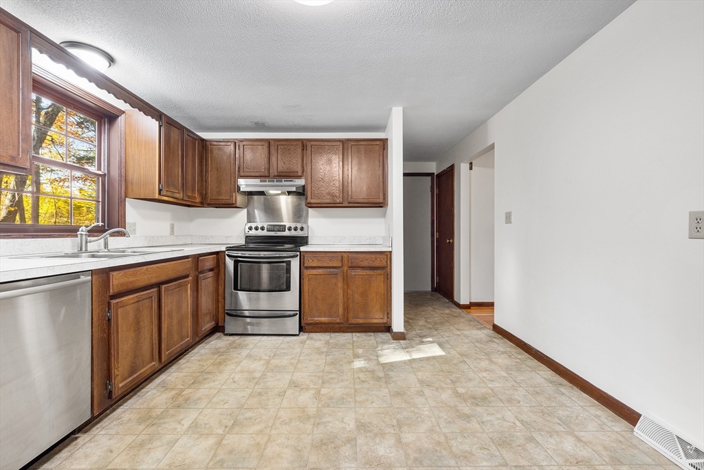 230 Irondequoit Road Franklin, MA 02038 - Photo 9 of 36 a kitchen with stainless steel appliances granite countertop a stove a sink and a refrigerator
