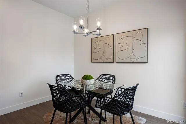 a view of a dining room with furniture and chandelier
