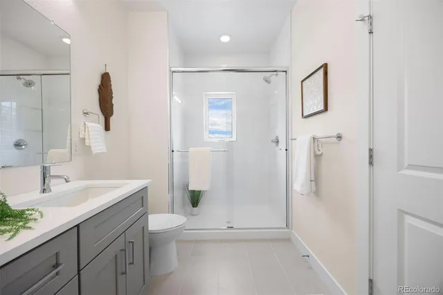 a bathroom with a shower a sink and mirror