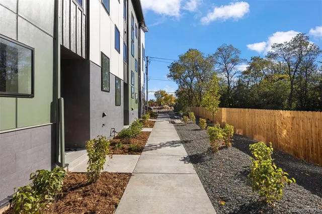 a view of a pathway that has potted plants
