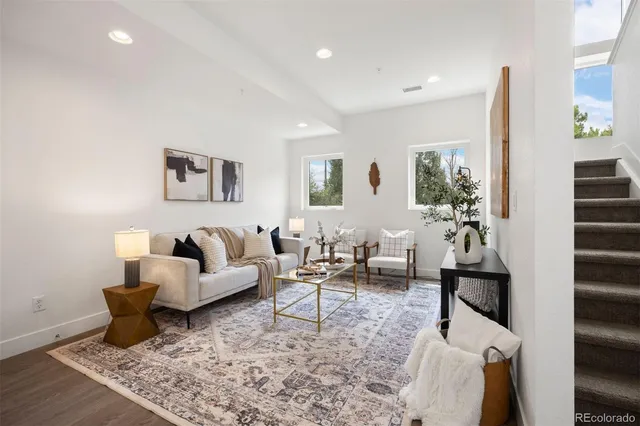 a living room with furniture and wooden floor