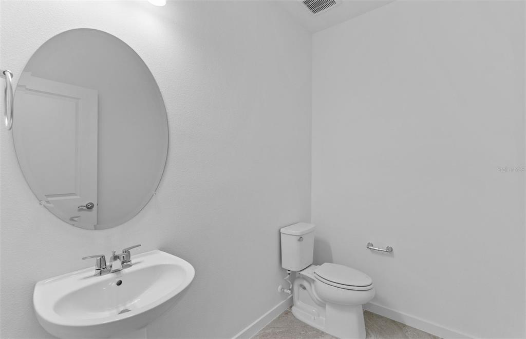 6909 Southwest 90th Place Ocala, FL 34476 - Photo 11 of 20 a bathroom with a sink mirror and toilet