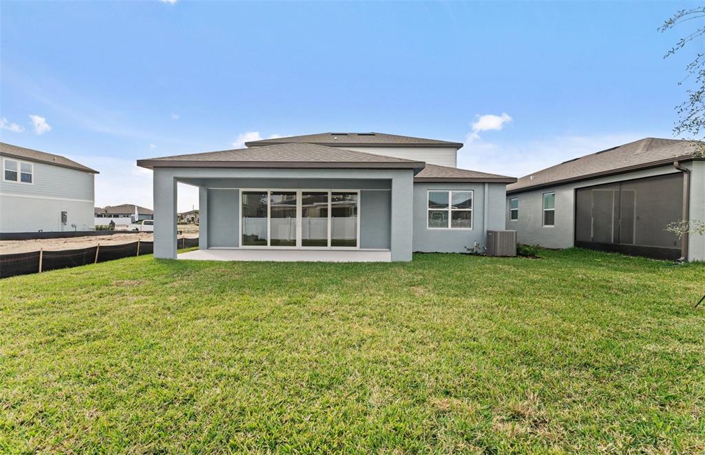 6909 Southwest 90th Place Ocala, FL 34476 - Photo 19 of 20 a view of a house with a backyard
