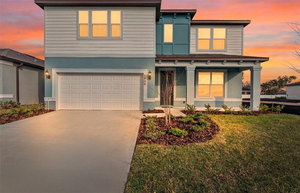 6909 Southwest 90th Place Ocala, FL 34476 - Photo 20 of 20 a front view of a house with garden