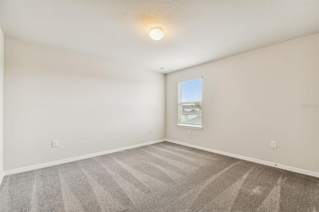 6909 Southwest 90th Place Ocala, FL 34476 - Photo 21 of 23 an empty room with a empty space and window