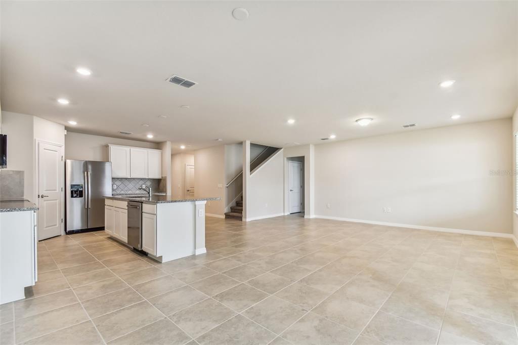 6909 Southwest 90th Place Ocala, FL 34476 - Photo 4 of 23 a view of kitchen with refrigerator sink and a stove top oven