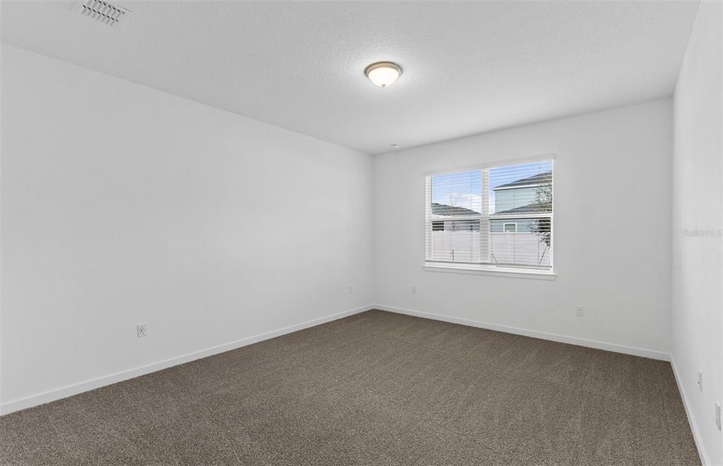 6909 Southwest 90th Place Ocala, FL 34476 - Photo 7 of 20 an empty room with a window