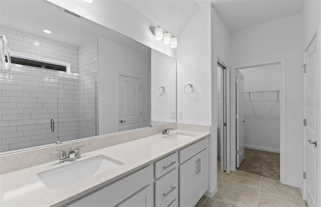 6909 Southwest 90th Place Ocala, FL 34476 - Photo 8 of 20 a spacious bathroom with a shower sink double and mirror
