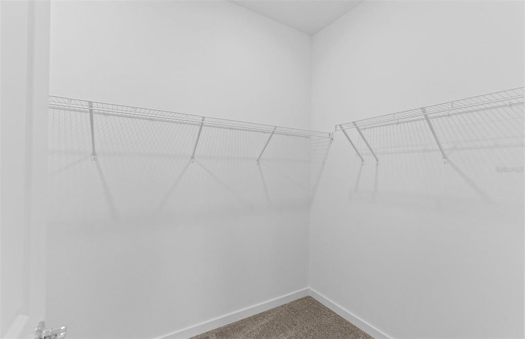 6909 Southwest 90th Place Ocala, FL 34476 - Photo 9 of 20 a view of a room with racks on the wall