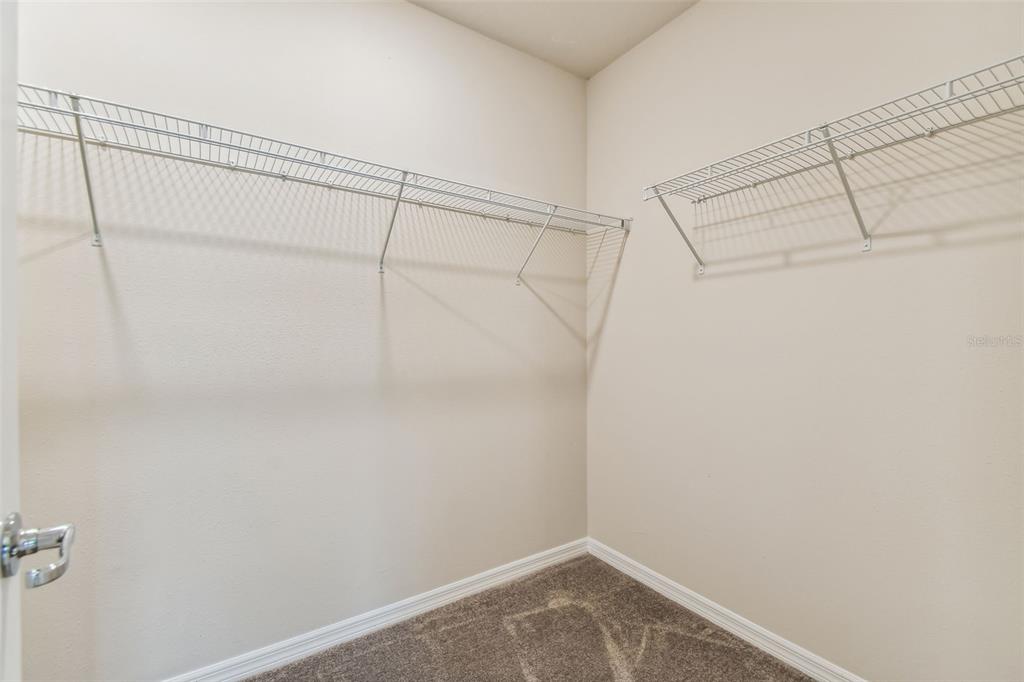 6909 Southwest 90th Place Ocala, FL 34476 - Photo 10 of 23 a view of a room with racks on the wall