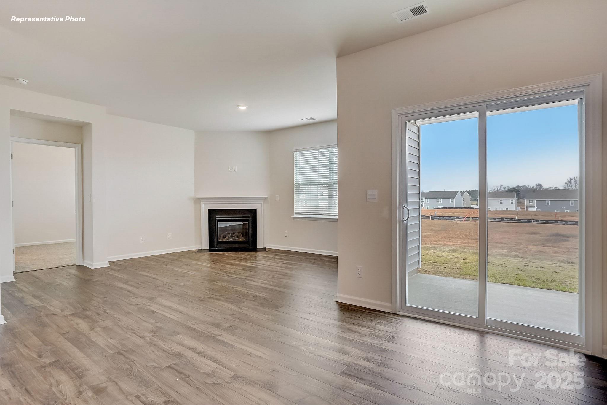 2687 Goose Fair Road Maiden, NC 28650 - Photo 3 of 24 an empty room with wooden floor and windows