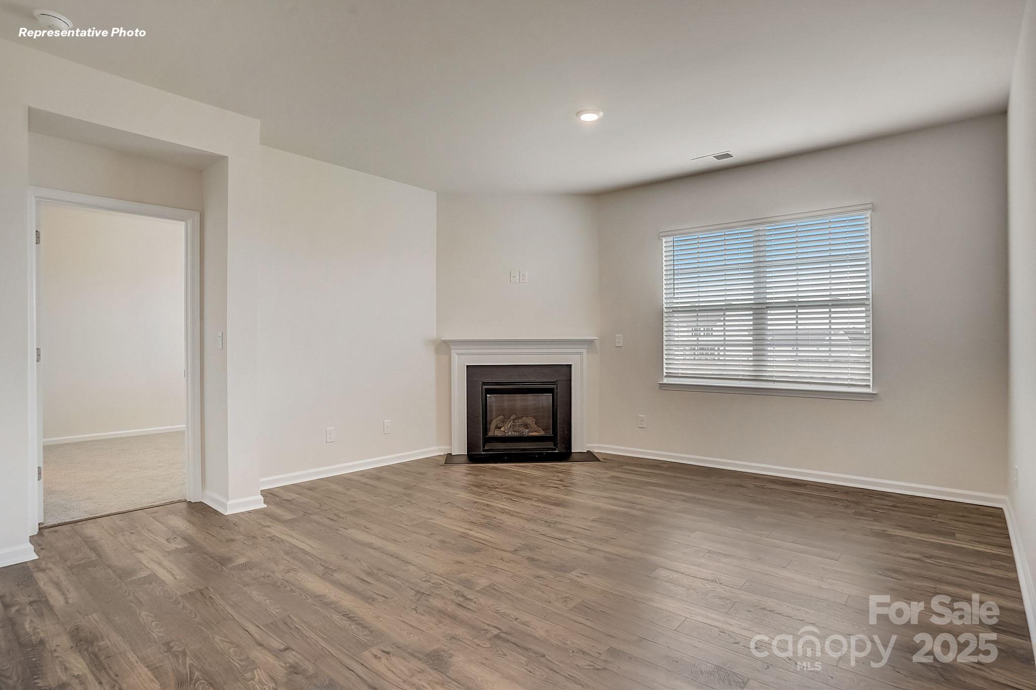 2687 Goose Fair Road Maiden, NC 28650 - Photo 5 of 24 an empty room with windows and fireplace