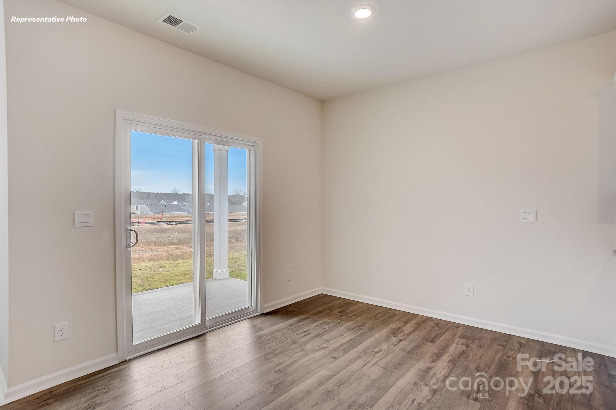 2687 Goose Fair Road Maiden, NC 28650 - Photo 10 of 24 a view of an empty room with wooden floor and a window