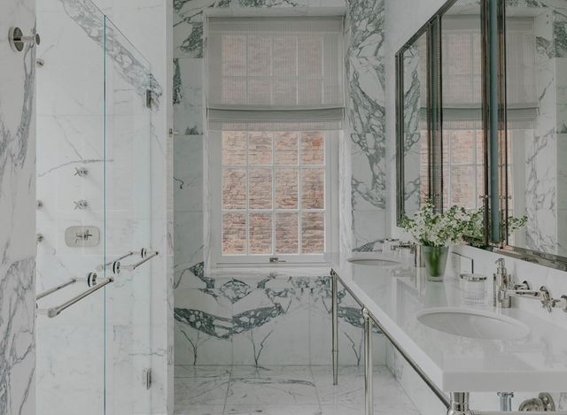 a bathroom with a granite countertop sink a mirror and shower