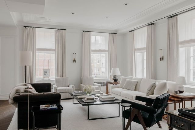 a living room with furniture and large windows