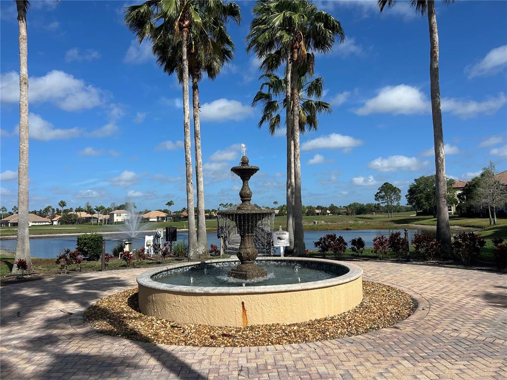 8143 Miramar Way, Unit 8143 Lakewood Ranch, FL 34202 - Photo 14 of 18 a view of a swimming pool with a table and chairs
