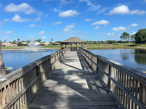a view of a balcony with wooden floor and lake view