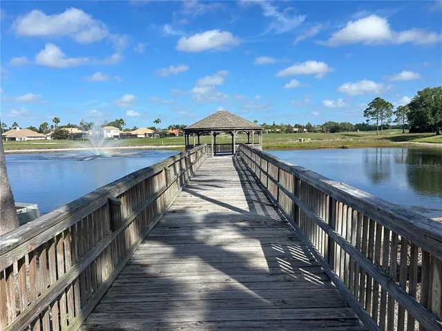 a view of a balcony with wooden floor and lake view