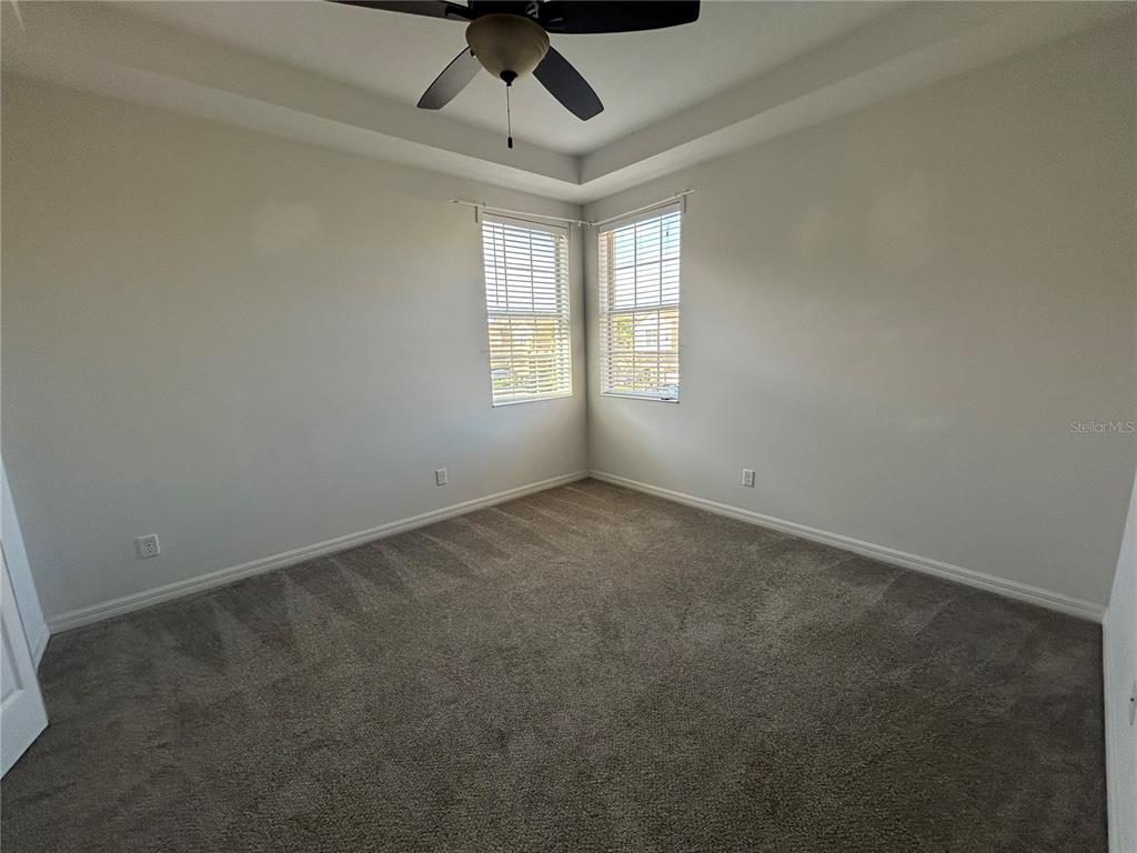 8143 Miramar Way, Unit 8143 Lakewood Ranch, FL 34202 - Photo 7 of 18 an empty room with a window and a ceiling fan