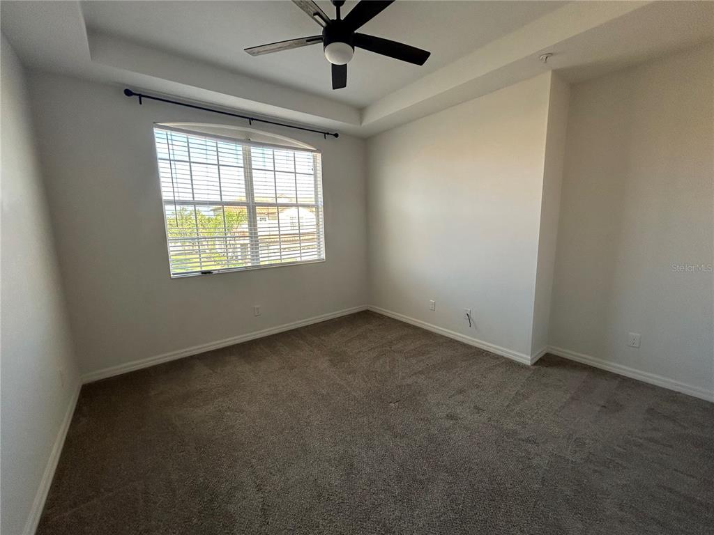 8143 Miramar Way, Unit 8143 Lakewood Ranch, FL 34202 - Photo 8 of 18 an empty room with a window and a fan