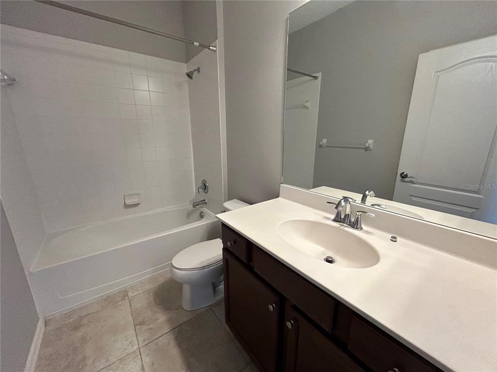 8143 Miramar Way, Unit 8143 Lakewood Ranch, FL 34202 - Photo 9 of 18 a bathroom with a sink a toilet and shower