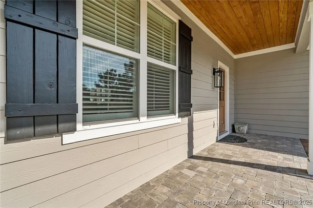 a view of a living room with kitchen island furniture and a wooden floor