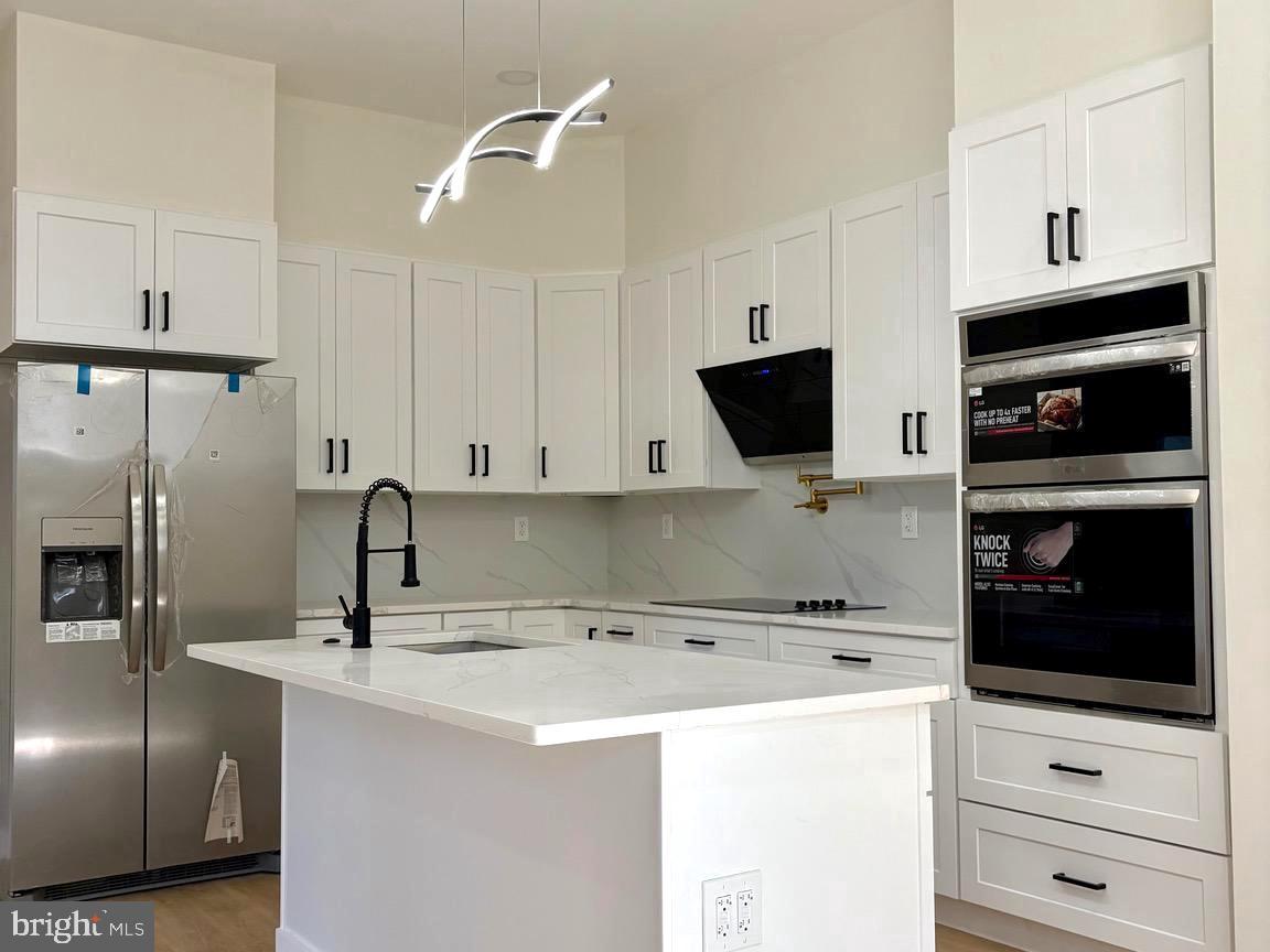 865 West Lancaster Avenue Bryn Mawr, PA 19010 - Photo 1 of 16 a kitchen with a refrigerator and a stove top oven