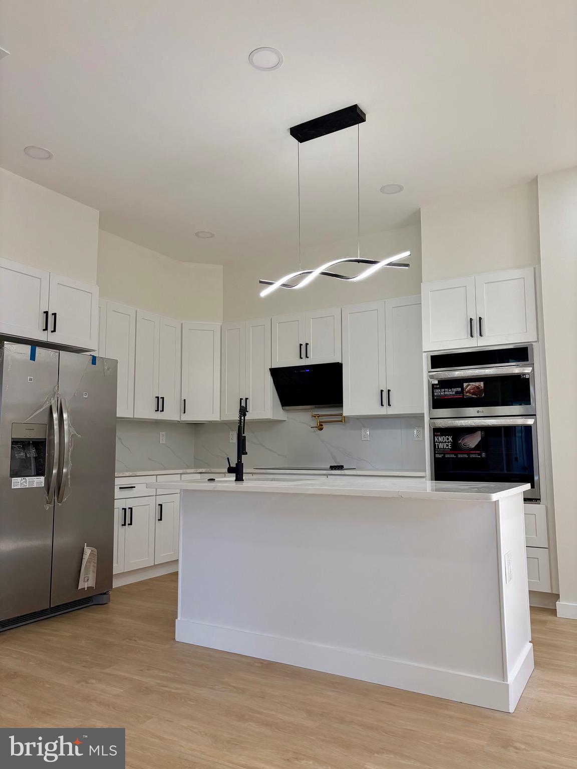 865 West Lancaster Avenue Bryn Mawr, PA 19010 - Photo 2 of 16 a large kitchen with stainless steel appliances a large counter top and a stove top oven