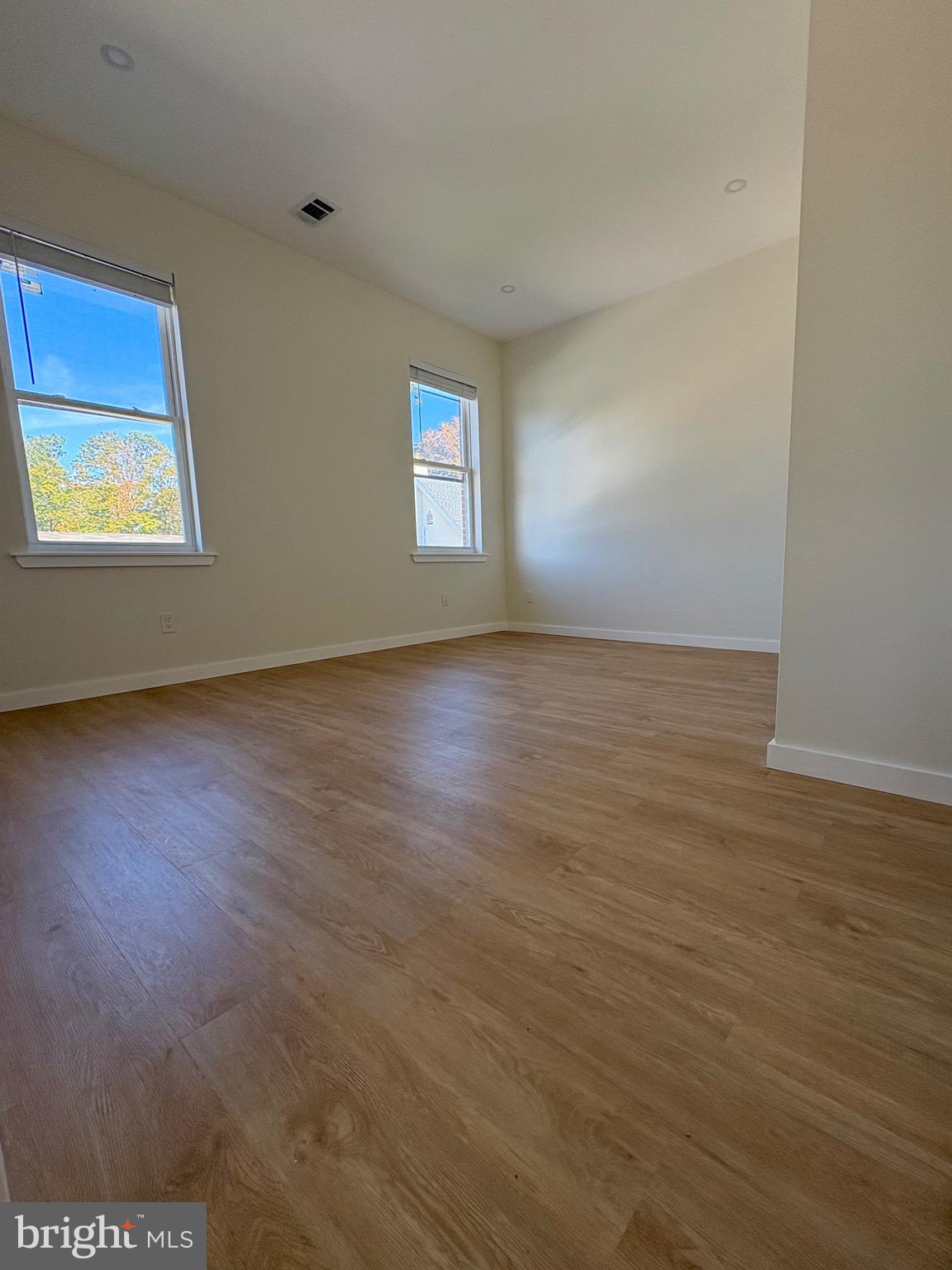 865 West Lancaster Avenue Bryn Mawr, PA 19010 - Photo 9 of 16 a view of an empty room with wooden floor and a window