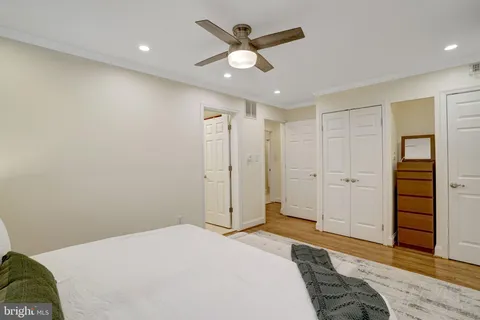 a bedroom with a bed and a potted plant