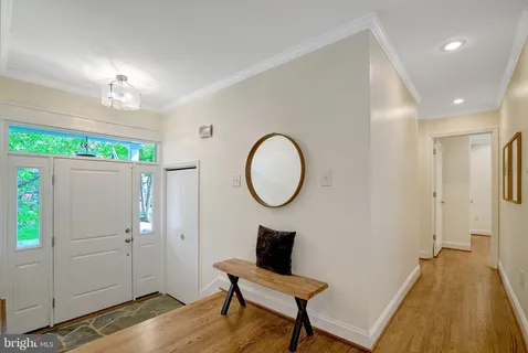 a view of a room with wooden floor cabinet and a potted plant