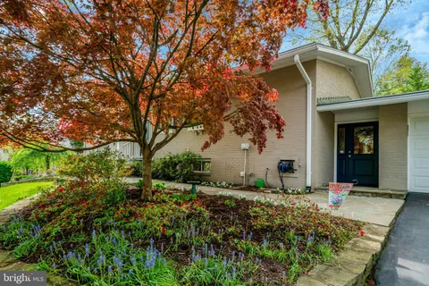 a bathroom with a sink a toilet and shower curtain